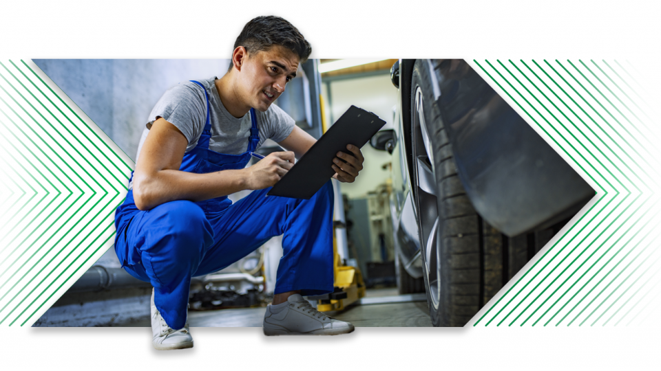 Dealership man reviewing information next to vehicle tires